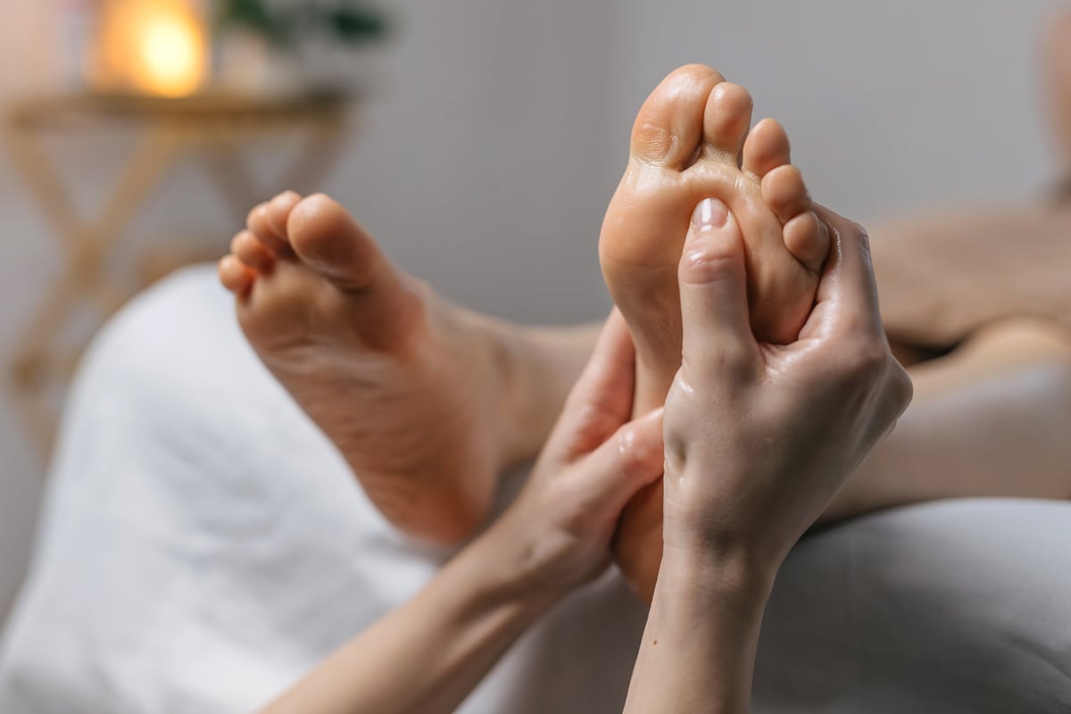 Close-up of foot massage in modern spa interior