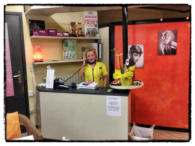 Woman in yellow shirt working at reception desk