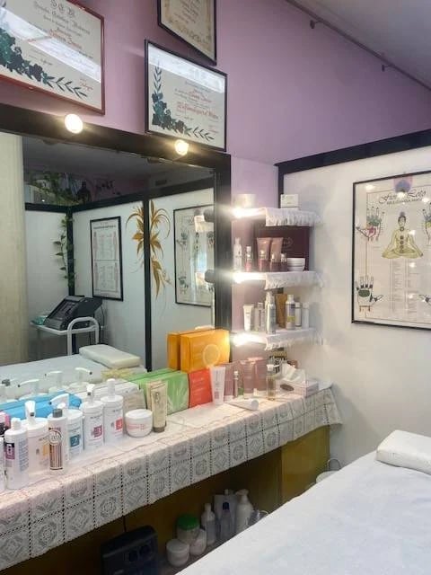 A beauty and skincare shop display with pink walls and illuminated shelves